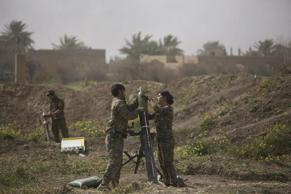 U.S.-backed Syrian Democratic Forces (SDF) soldiers prepare to fire mortars at Islamic State militant positions in Baghouz, Syria, Wednesday, March 13, 2019. (AP Photo/Maya Alleruzzo)