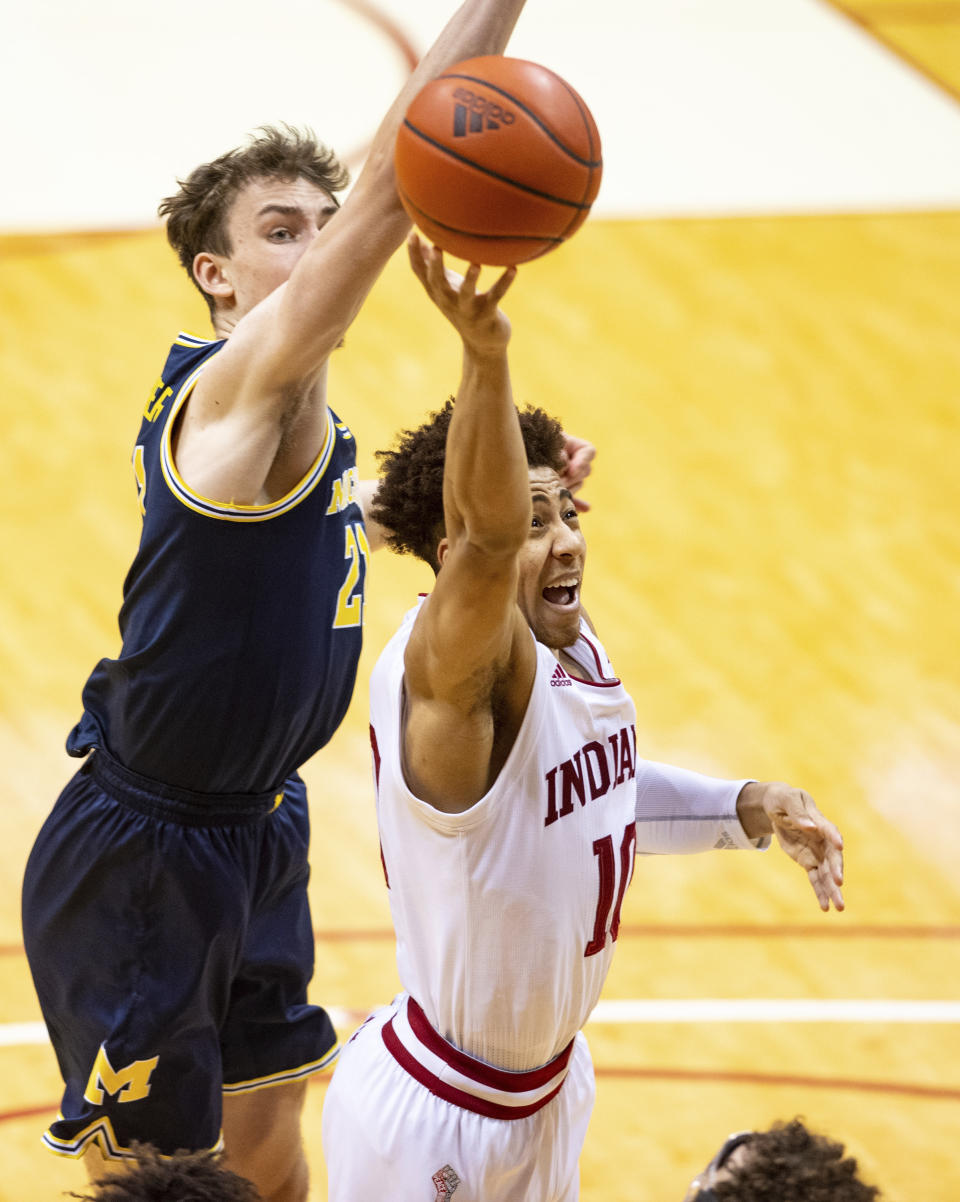 Indiana guard Rob Phinisee (10) drives to the basket with the ball as Michigan guard Franz Wagner (21) attempts to block his shot during the second half of an NCAA college basketball game, Saturday, Feb. 27, 2021, in Bloomington, Ind. (AP Photo/Doug McSchooler)