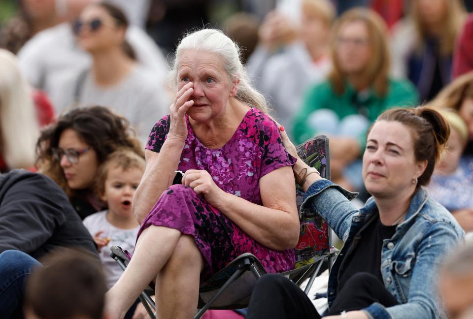A woman wipes away a tear as mourners gather in Hyde Park for the funeral (REUTERS)