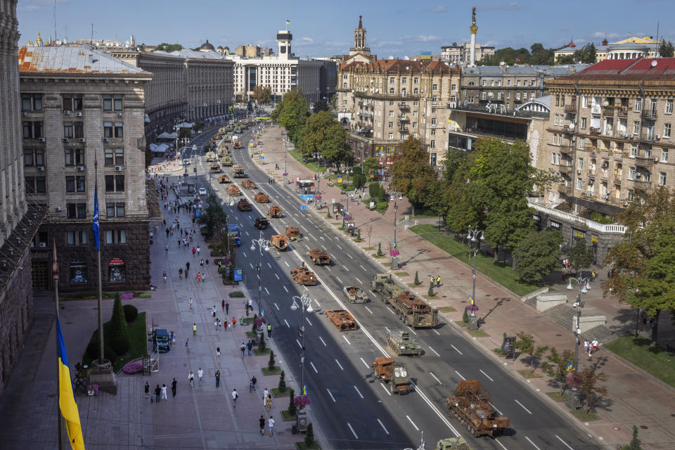 People look at a large number of burned out and captured Russian tanks and infantry carriers which have been on display on the central Khreshchatyk boulevard as Ukrainians prepare to mark Independence Day in Kyiv, Ukraine, Tuesday, Aug. 22. Ukraine marks Independence Day on Aug. 24. (AP Photo/Efrem Lukatsky)