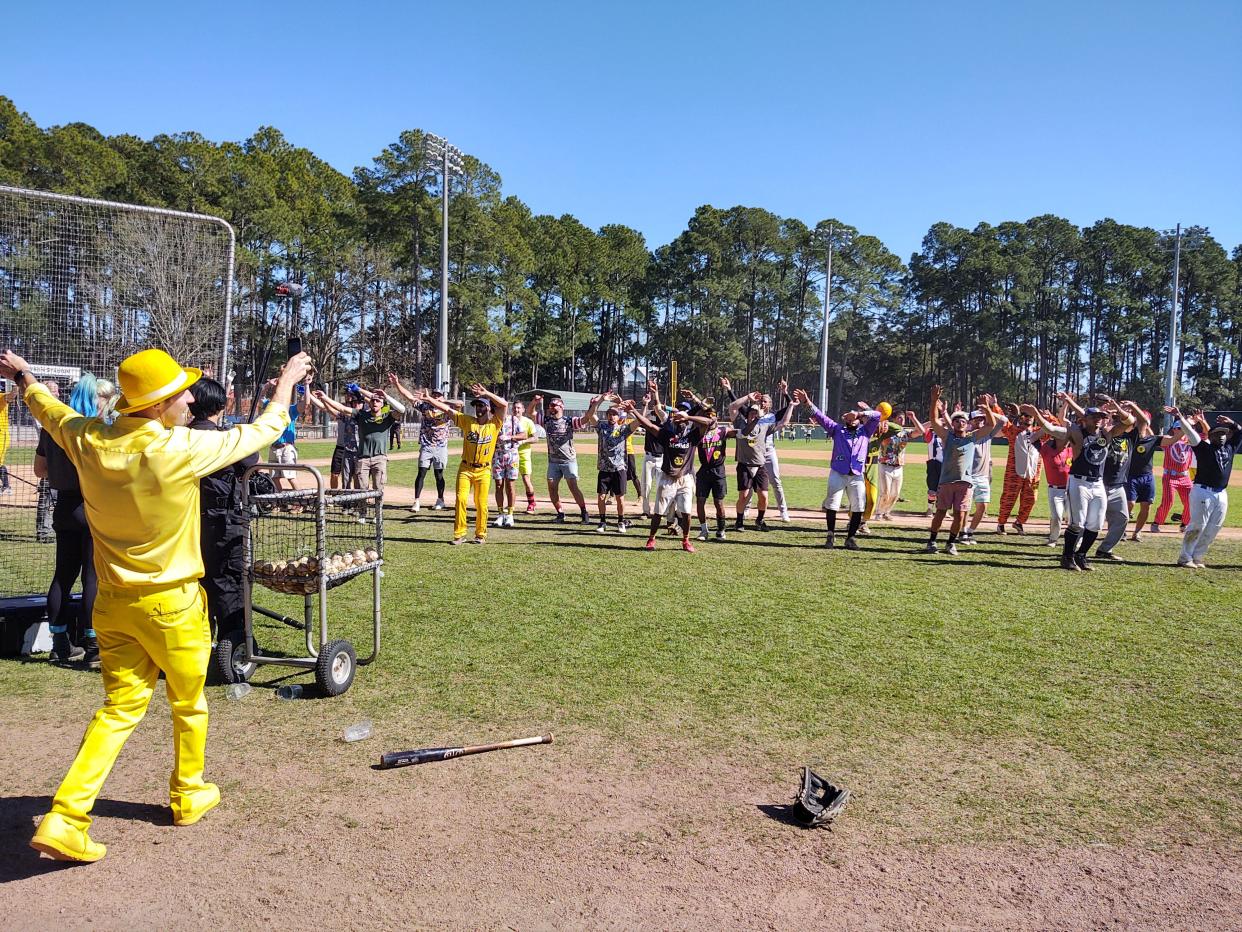 Savannah Bananas owner Jesse Cole, in his customary yellow tuxedo and hat, leads prospects through their paces on "Hey! Baby" during the tryout Saturday for the Premier Team at Grayson Stadium.