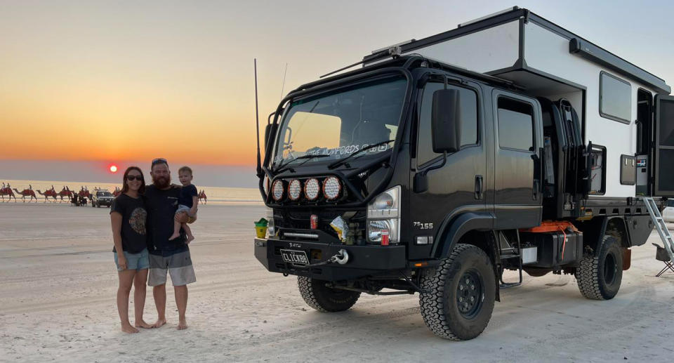 Mumford family with their truck and camper at sunset.