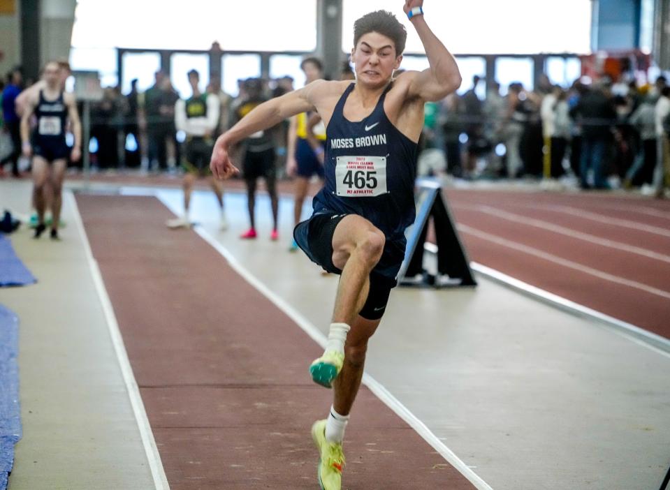 Salter Arms on his way to long jump win.