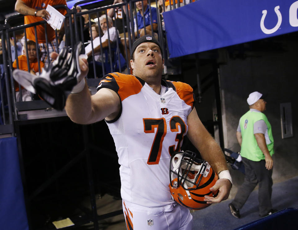 FILE - In this Sept. 3, 2015, file photo, Cincinnati Bengals' Eric Winston (73) throws his gloves to a fan following an NFL preseason football game against the Indianapolis Colts in Indianapolis. Avoiding a work stoppage in 2021 could depend on whether players can secure more guaranteed money in the next collective bargaining negotiations with the NFL. Winston says the best way to ensure more guaranteed money for players is to get them to free agency sooner. (AP Photo/AJ Mast, File)