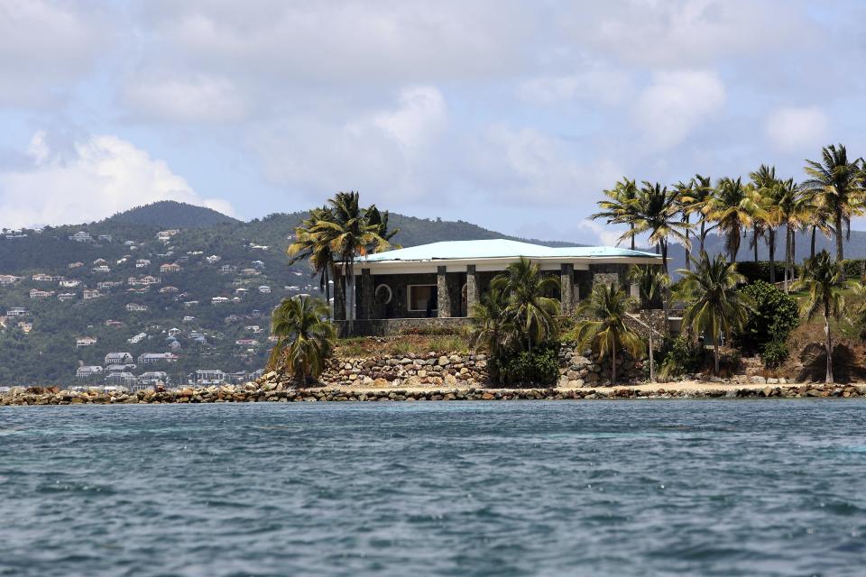 A view of Jeffrey Epstein's stone mansion on Little St. James Island, a property owned by Jeffrey Epstein, is backdropped by St. John Island, Wednesday, August 14, 2019. Federal authorities consider Little St. James Island to have been Epstein’s primary residence in the United States, a place where at least one alleged victim said in a court affidavit that she participated in an orgy as well as had sex with Epstein and other people. (AP Photo/Gabriel Lopez Albarran)