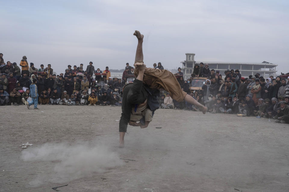 Afghan men wrestle in Kabul, Afghanistan, Friday, Dec. 3 , 2021. The scene is one played out each week after Friday prayers in the sprawling Chaman-e-Huzori park in downtown Kabul, where men, mainly from Afghanistan's northern provinces, gather to watch and to compete in pahlawani, a traditional form of wrestling. (AP Photo/ Petros Giannakouris)