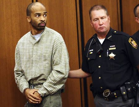 Michael Madison (L) is led out of court after appearing for a pre-trial hearing in Cleveland in this September 9, 2013, file photo. REUTERS/Aaron Josefczyk/Files