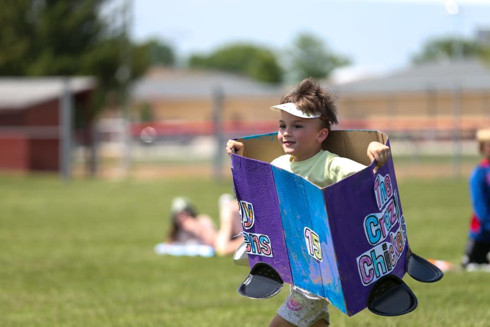 A Mayflower Mill Elementary School kindergartener runs around Mayflower Mill Elementary School's Kindy 500 course set up in McCutcheon High School’s soccer field, on Monday, May 22, 2023, in Lafayette, Indiana.