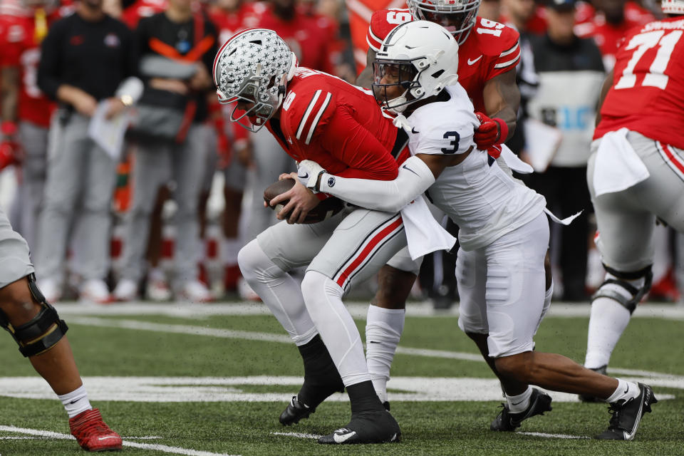 Penn State defensive back Johnny Dixon, right, sacks Ohio State quarterback Kyle McCord during the first half of an NCAA college football game Saturday, Oct. 21, 2023, in Columbus, Ohio. (AP Photo/Jay LaPrete)