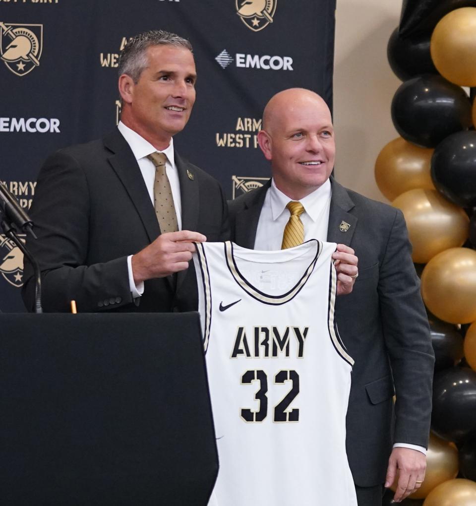 Army West Point Director of Athletics Mike Buddie, left, introduces the 32nd men's basketball head coach, Kevin Kuwik, during a press conference in the Kimsey Hall's Nowack Auditorium on the campus of the United States Military Academy at West Point on Thursday, April 13, 2023. 