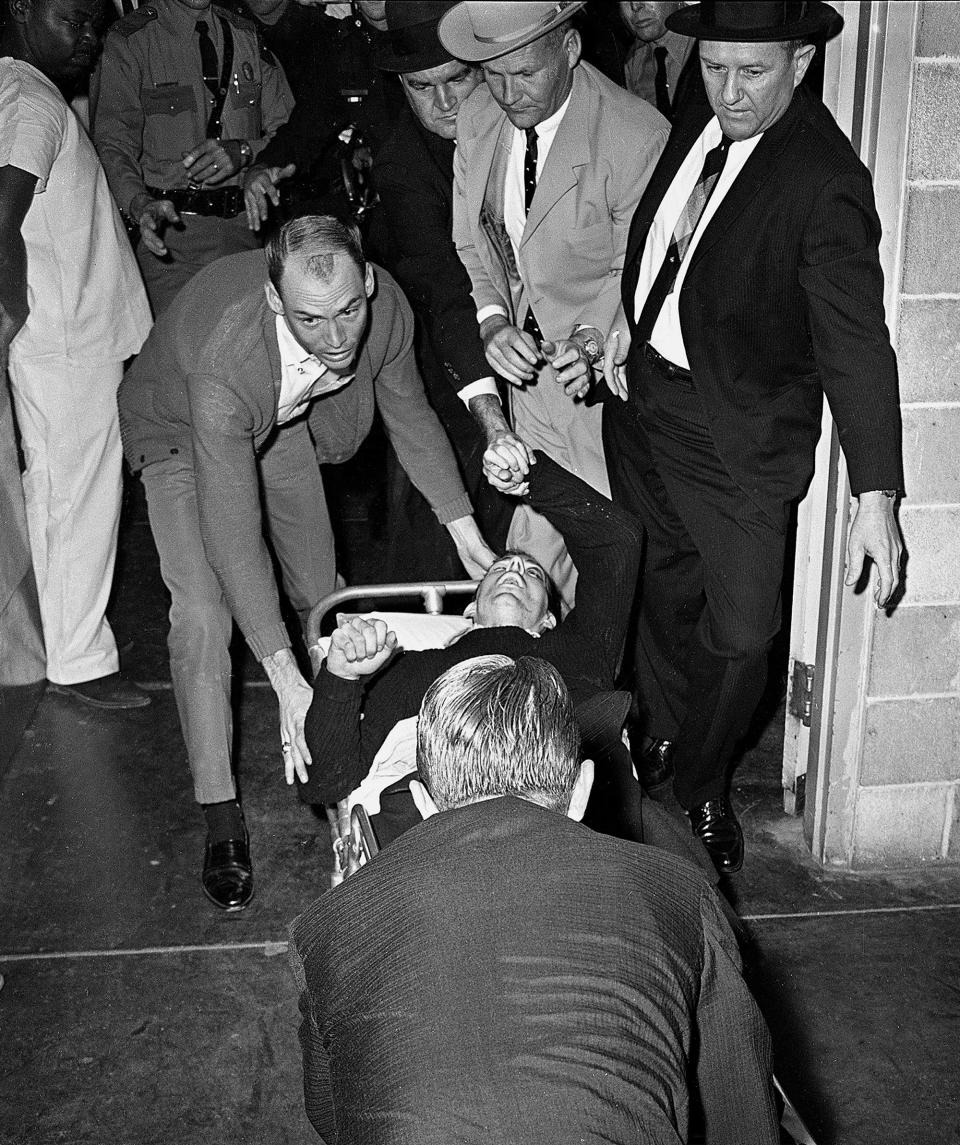 <p>Lee Harvey Oswald, accussed assassin of President John F. Kennedy, is rushed into Parkland Hospital in Dallas, Nov. 24, 1963. Nightclub owner Jack Ruby shot and killed Oswald as he was being transferred through the city jail’s underground garage. Parkland Hospital also treated President Kennedy’s fatal wounds two days earlier. (Photo: Ted Powers/AP) </p>