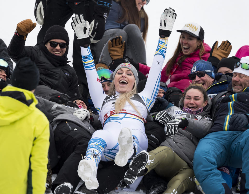 Lindsey Vonn of the United States celebrates with the US Ski members after the flowers ceremony of the women downhill race at the 2019 FIS Alpine Skiing World Championships in Are, Sweden Sunday, Feb. 10, 2019. (Jean-Christophe Bott/Keystone via AP)