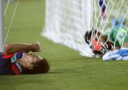 Japan's Yoshito Okubo (L) lies on the ground after failing to score a goal as Greece's goalkeeper Orestis Karnezis looks on during their 2014 World Cup Group C soccer match at the Dunas arena in Natal June 19, 2014. REUTERS/Toru Hanai (BRAZIL - Tags: SOCCER SPORT WORLD CUP TPX IMAGES OF THE DAY)