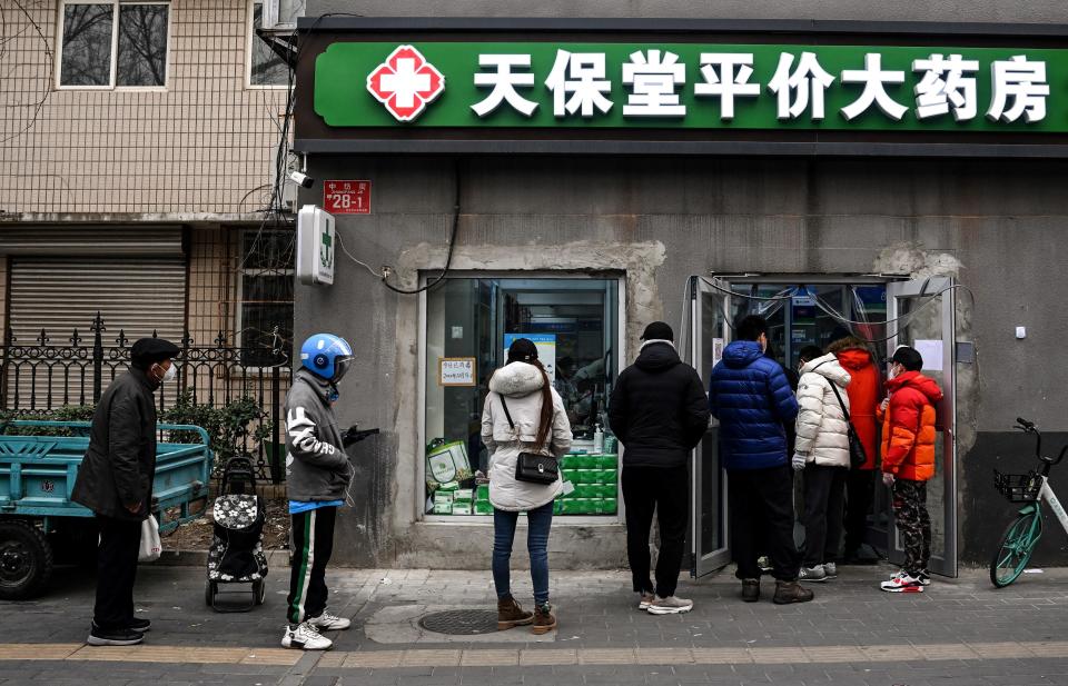 People wait to buy medicine at a drug store in Beijing, China, December 9, 2022. / Credit: NOEL CELIS/AFP/Getty