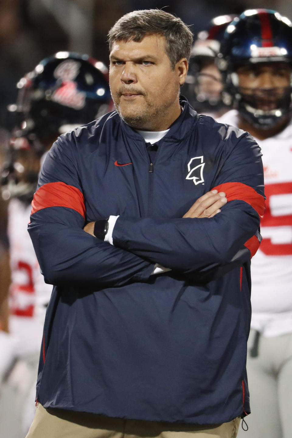 In this Nov. 28, 2019 photo, Mississippi head coach Matt Luke watches his players warm up prior to an NCAA college football game against Mississippi State, in Starkville, Miss. Mississippi has fired Luke, three days after his third non-winning season ended with an excruciating rivalry game loss. Athletic director Keith Carter said Sunday, Dec. 1, 2019 the decision to change coaches was made after evaluating the trajectory of the program and not seeing enough “momentum on the field. (AP Photo/Rogelio V. Solis)