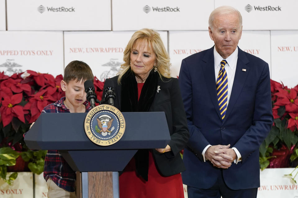 President Joe Biden and first lady Jill Biden listen as a child reads a passage from "How the Grinch Stole Christmas" by Dr. Seuss during a Toys for Tots sorting event at Joint Base Myer-Henderson Hall in Arlington, Va., Monday, Dec. 12, 2022. (AP Photo/Patrick Semansky)