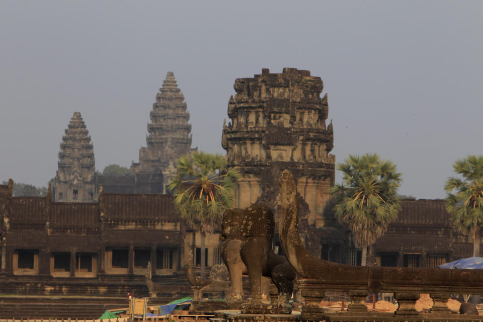 FILE - In this March 3, 2018, file photo, a view from outside Angkor Wat temple is seen in Siem Reap, northwestern Cambodia. Cambodia is closing the Angkor temple complex to visitors because of a growing COVID-19 outbreak. On Thursday, April 8, 2021, the Health Ministry said 113 cases were reported from local transmission, with two deaths. The ministry traced the outbreak to a foreign resident who broke hotel quarantine to visit a nightclub. (AP Photo/Heng Sinith, File)