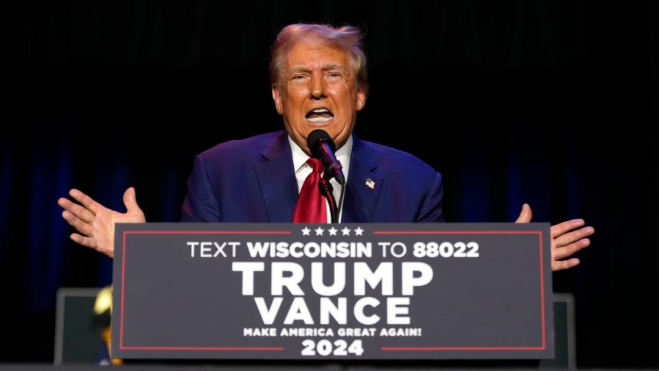 Trump seemed to get distracted by a fly during a rally speech on Saturday. (AP)