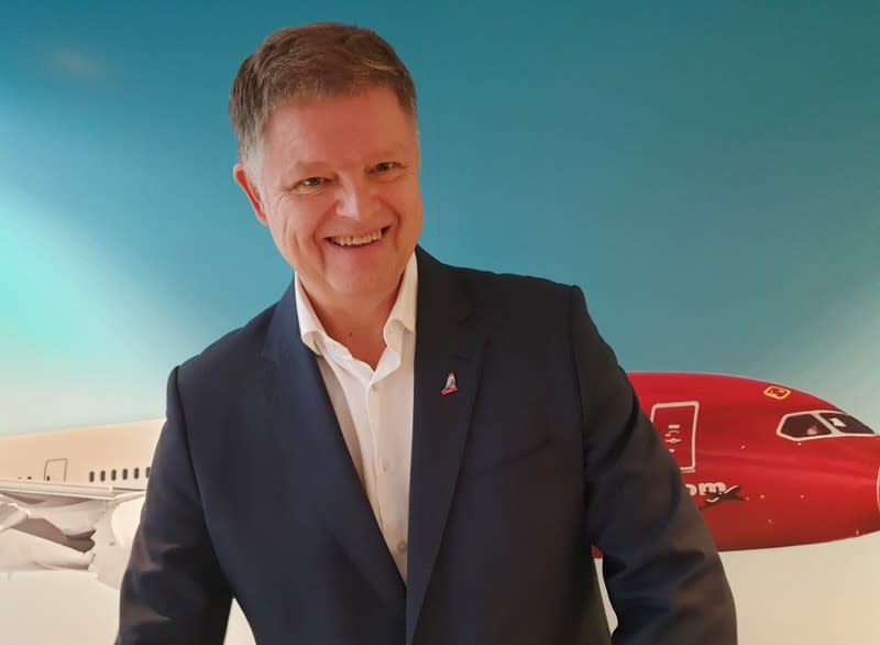 Norwegian Air CEO Schram smiles during a news conference in Oslo