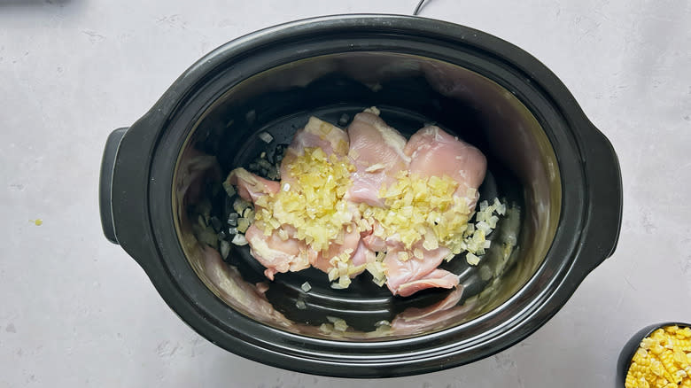 chicken, garlic, and onions in slow cooker