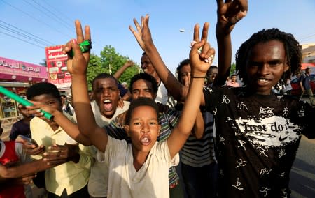 Sudanese people chant slogans as they celebrate, after Sudan's ruling military council and a coalition of opposition and protest groups reached an agreement to share power during a transition period leading to elections, along the streets of Khartoum