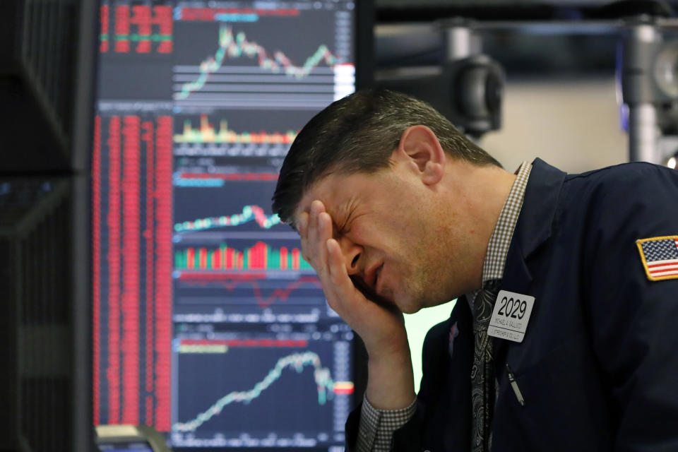 Trader Michael Gallucci works at his post on the floor of the New York Stock Exchange, Wednesday, March 11, 2020. Stocks are closing sharply lower on Wall Street, erasing more than 1,400 points from the Dow industrials, as investors wait for a more aggressive response from the U.S. government to economic fallout from the coronavirus. (AP Photo/Richard Drew)