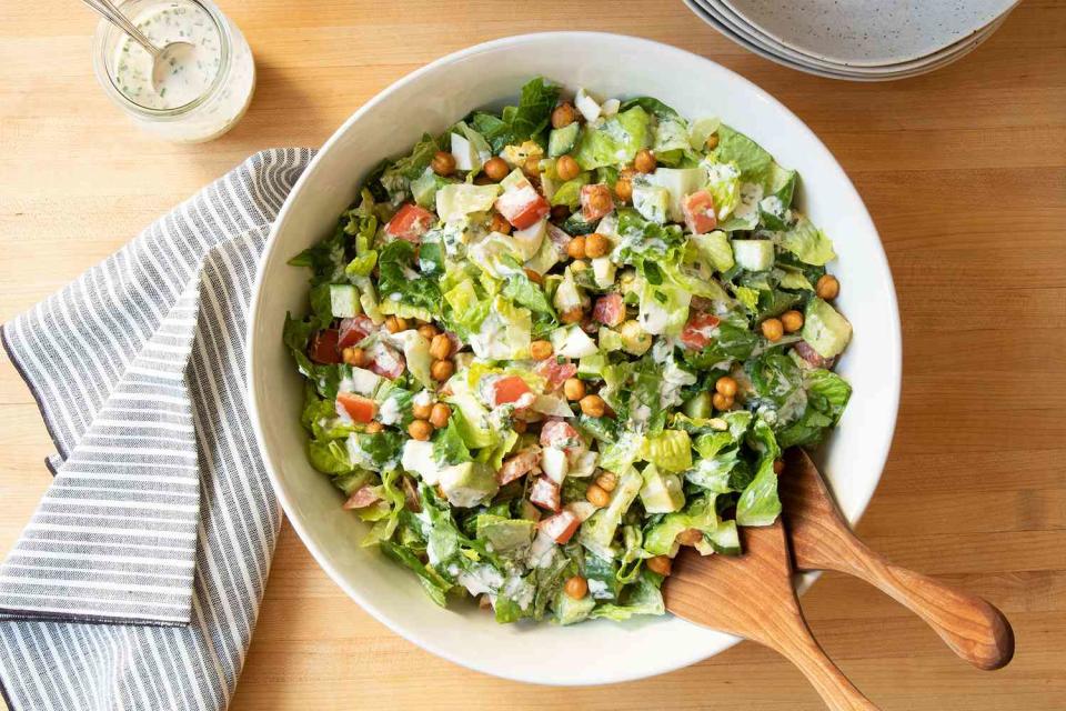 <p>In place of bacon, this satisfying salad uses store-bought crispy chickpeas for lower saturated fat and less prep time. Using fresh herbs, bright citrus and a creamy base of yogurt and mayonnaise for the dressing gives it a flavorful finish. <a href="https://www.eatingwell.com/recipe/7903279/chopped-cobb-salad-with-creamy-garlic-dressing/" rel="nofollow noopener" target="_blank" data-ylk="slk:View Recipe" class="link ">View Recipe</a></p>
