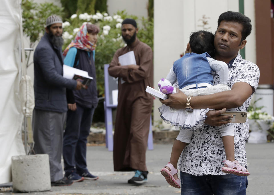 A father carries his daughter as he leaves the the Al Noor mosque in Christchurch, New Zealand, Sunday, March 15, 2020. A national memorial in New Zealand to commemorate the 51 people who were killed when a gunman attacked two mosques one year ago has been canceled due to fears over the new coronavirus. (AP Photo/Mark Baker)