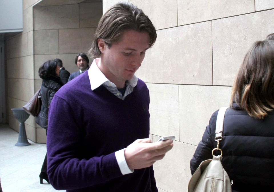 Raffaele Sollecito checks his smart phone as he enters the Florence court, Italy, Thursday, Jan. 9, 2013. The defense lawyer for the former boyfriend of U.S. exchange student Amanda Knox told an appeals court Thursday that the young lovers were blamed by authorities for the murder of British student Meredith Kercher to calm any fears that a monster was loose in their Italian university town. Defender Giulia Bongiorno said her client, Raffaele Sollecito, and Knox were identified as suspects in a "record" four days after the murder in the picturesque central town of Perugia because authorities "did not want to think that a stranger, a monster, could have entered a house and murdered a student." (AP Photo/Matteo Bovo, Lapresse)