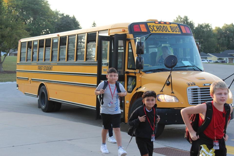 Students get off the school bus at Edison Middle School in Green Bay in September 2023.