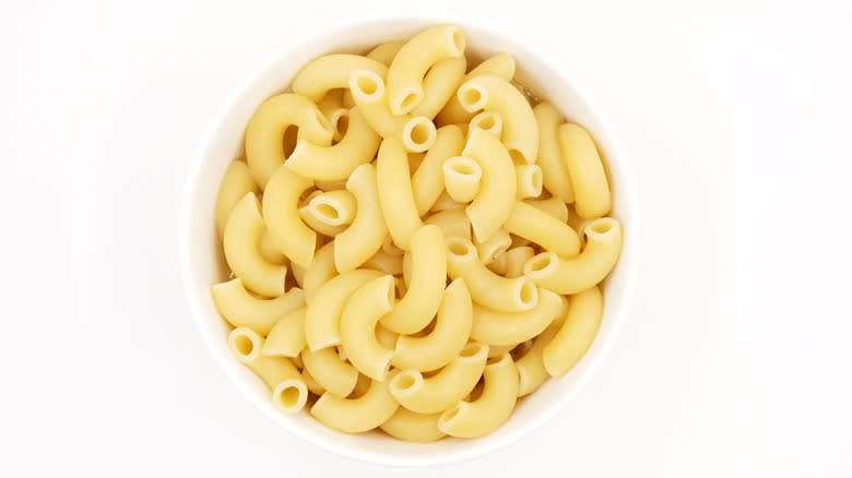 Cooked macaroni noodles in white dish