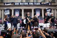 USA women's soccer player Megan Rapinoe holds the trophy in front of the City Hall after a ticker tape parade for the women's World Cup champions on July 10, 2019 in New York. - Amid chants of "equal pay," "USA" and streams of confetti, the World Cup-winning US women's soccer team was feted by tens of thousands of adoring fans with a ticker-tape parade in New York on Wednesday. (Photo by Johannes Eisele/AFP/Getty Images)