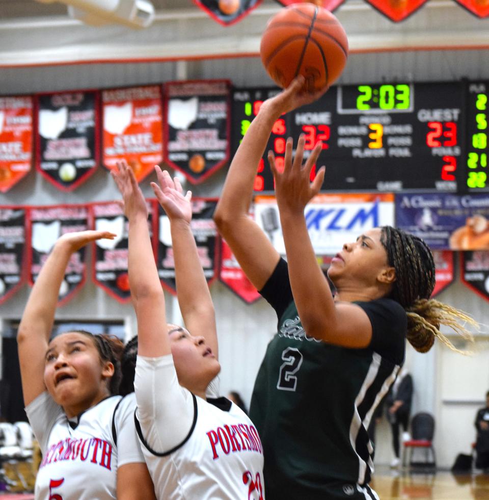Saniyah Hall gets off a jumper over a pair of Portsmouth defenders Monday at Classic in the Country. After a record-setting 43-point effort on Sunday, Hall scored 16 in a losing effort against Portsmouth.
