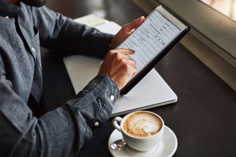 A close up of a form as it appears on a tablet screen; a person is using their finger to scroll.