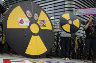 Members of environmental civic groups shout slogans during a rally to denounce the Japanese government's decision to release treated radioactive water into the sea from the damaged Fukushima nuclear power plant, outside of a building which houses Japanese Embassy, in Seoul, South Korea, Tuesday, Aug. 22, 2023. Japan will start releasing treated and diluted radioactive wastewater from the Fukushima Daiichi nuclear plant into the Pacific Ocean as early as Thursday, a controversial but essential early step in the decades of work to shut down the facility 12 years after its meltdown disaster. (AP Photo/Lee Jin-man)