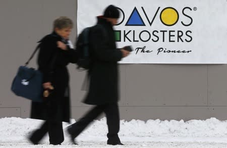 Attendees walk outside the Congress Center during the Annual Meeting 2016 of the World Economic Forum (WEF) in Davos, Switzerland January 20, 2016. REUTERS/Ruben Sprich