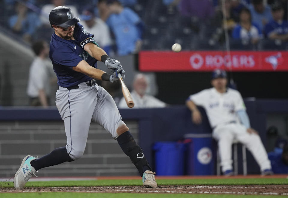 Seattle Mariners catcher Cal Raleigh (29) hits the game winning two run home run during the tenth inning of a baseball game against the Toronto Blue Jays in Toronto on Wednesday, April 10, 2024. (Nathan Denette/The Canadian Press via AP)