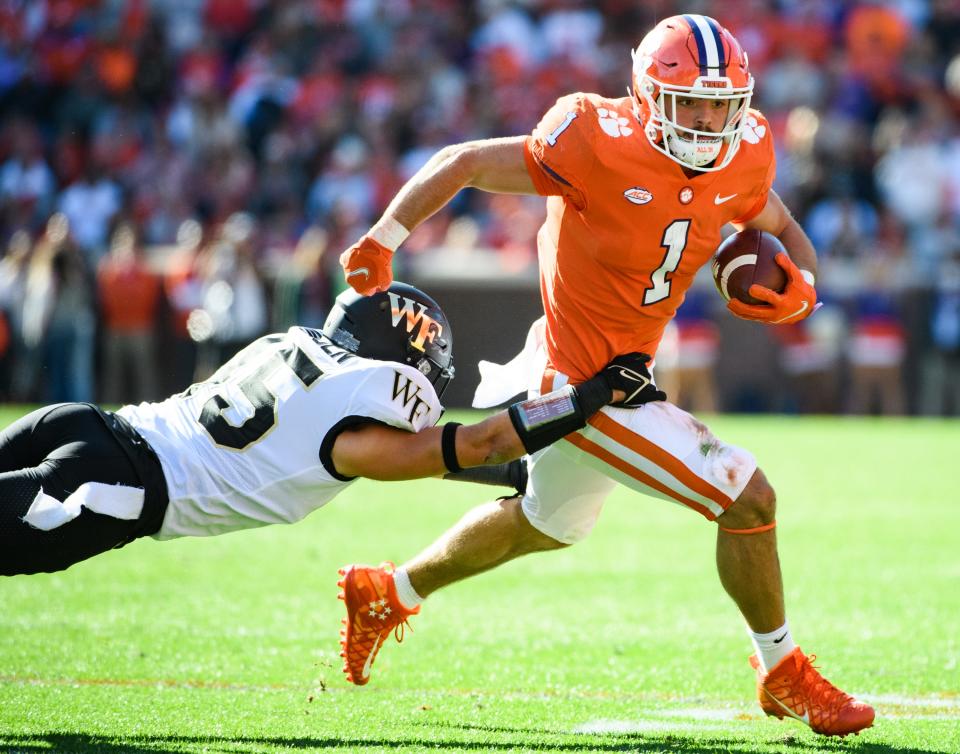 Clemson running back Will Shipley (1) attempts to evade Wake Forest defensive back Nick Andersen (45) during their game at Memorial Stadium Saturday, Nov. 20, 2021.