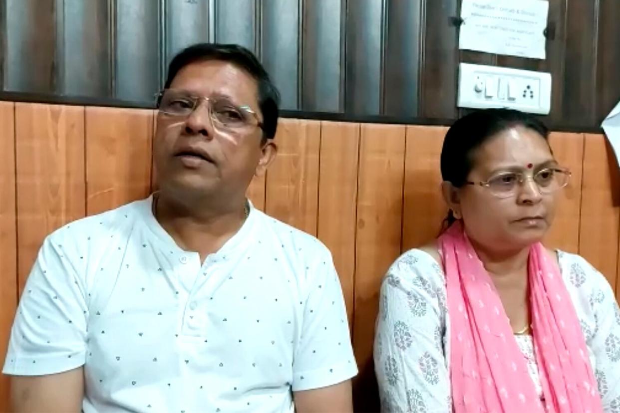 This image from video shows Sanjeev Ranjan Prasad, a 61-year-old retired government officer, and his wife Sadhana Prasad wait at a lawyer's chamber in Haridwar, India, Thursday, May 12, 2022. The Indian couple has sued their pilot son and daughter-in-law in a court demanding a grandchild within a year or compensation of 50 million rupees ($675,675). Prasad said this was an emotional and sensitive issue for him and his wife and they cannot wait any longer. His son got married six years ago