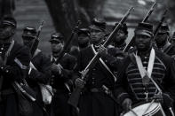 This image released by Apple TV+ shows Will Smith, center, in a scene from "Emancipation." (Quantrell Colbert/Apple TV+ via AP)