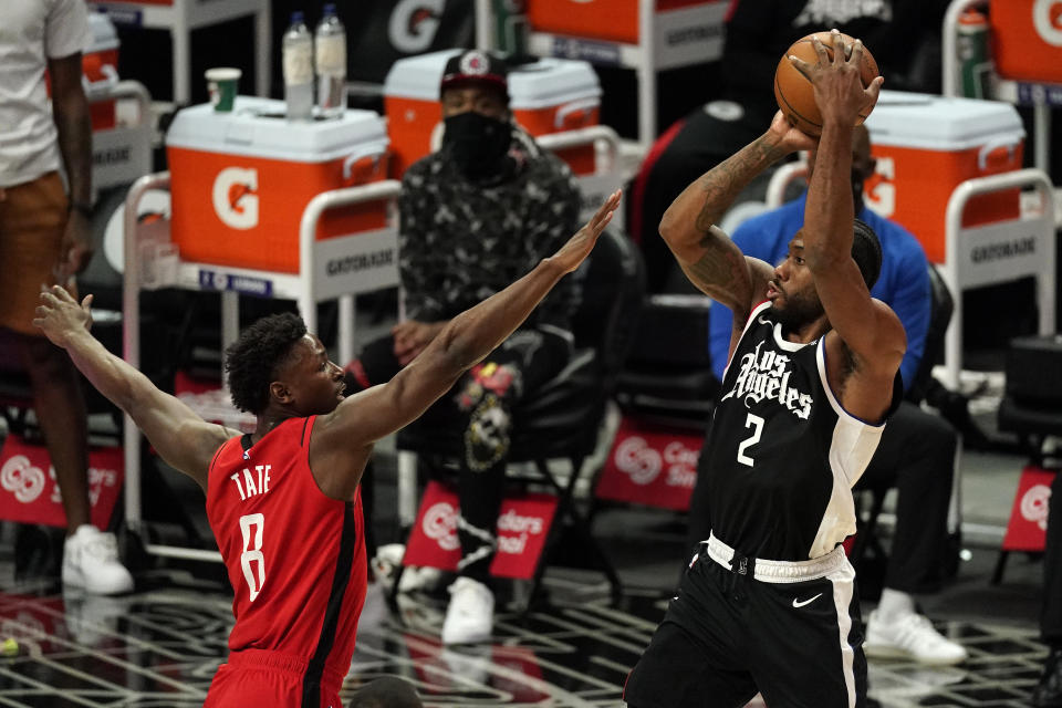 Los Angeles Clippers forward Kawhi Leonard, right, shoots as Houston Rockets forward Jae'Sean Tate defends during the first half of an NBA basketball game Friday, April 9, 2021, in Los Angeles. (AP Photo/Mark J. Terrill)