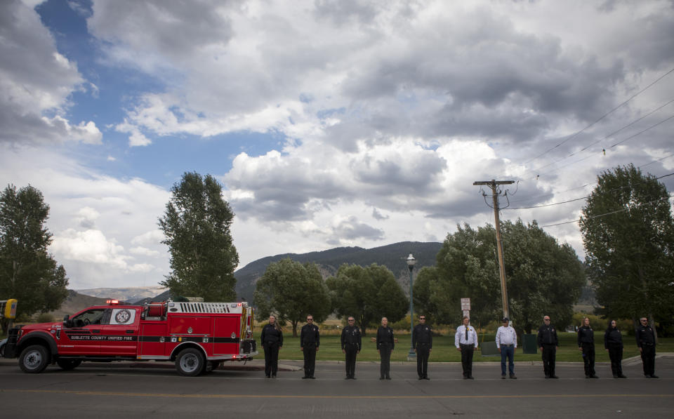 Local law enforcement prepare to salute Marine Lance Cpl. Rylee McCollum during his procession, in Jackson, Wyo., Friday, Sept. 10, 2021. McCollum was one of the service members killed in Afghanistan after a suicide bomber attacked Hamid Karzai International Airport on Aug. 26. (AP Photo/Amber Baesler)