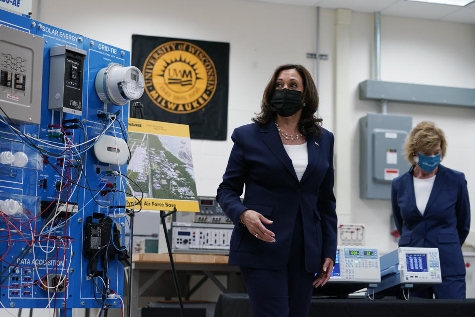 FILE - In this May 4, 2021, file photo Vice President Kamala Harris tours clean energy laboratories with Sen. Tammy Baldwin, D-Wis., at the University of Wisconsin-Milwaukee during a visit to promote President Joe Biden's $2 trillion jobs and infrastructure plan, in Milwaukee. President Joe Biden’s hope of pouring billions of dollars into green infrastructure investments is running into the political obstacle of winning over Republican votes. Biden wants his infrastructure package to include ways to fight climate change. (AP Photo/Susan Walsh, File)