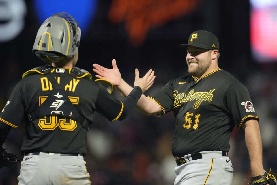 Pittsburgh Pirates catcher Jason Delay, left, celebrates with pitcher David Bednar (51) after the Pirates defeated the San Francisco Giants in a baseball game in San Francisco, Tuesday, May 30, 2023. (AP Photo/Jeff Chiu)