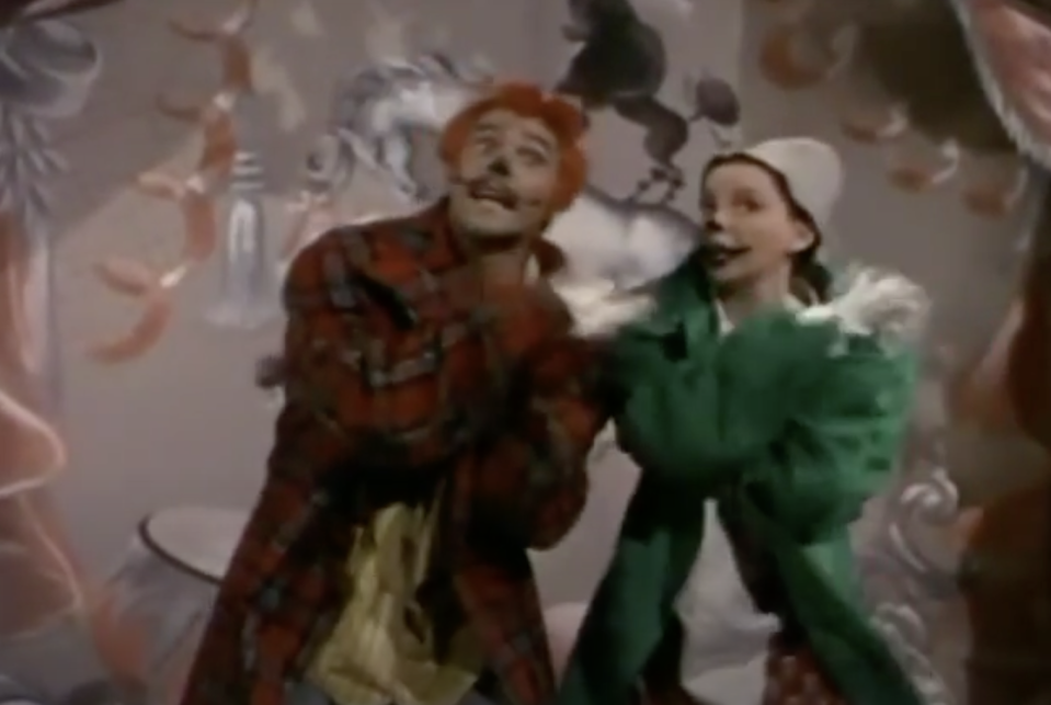 Ray Bolger and Judy Garland in a scene from The Wizard of Oz, dressed in bizarre costumes during the performance