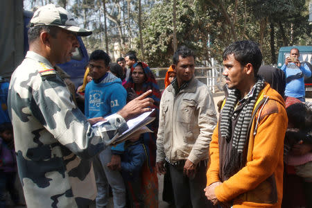 A Border Security Force (BSF) official registers the names of Rohingya Muslims after they were detained while crossing the India-Bangladesh border from Bangladesh, at Raimura village on the outskirts of Agartala, January 22, 2019. REUTERS/Jayanta Dey