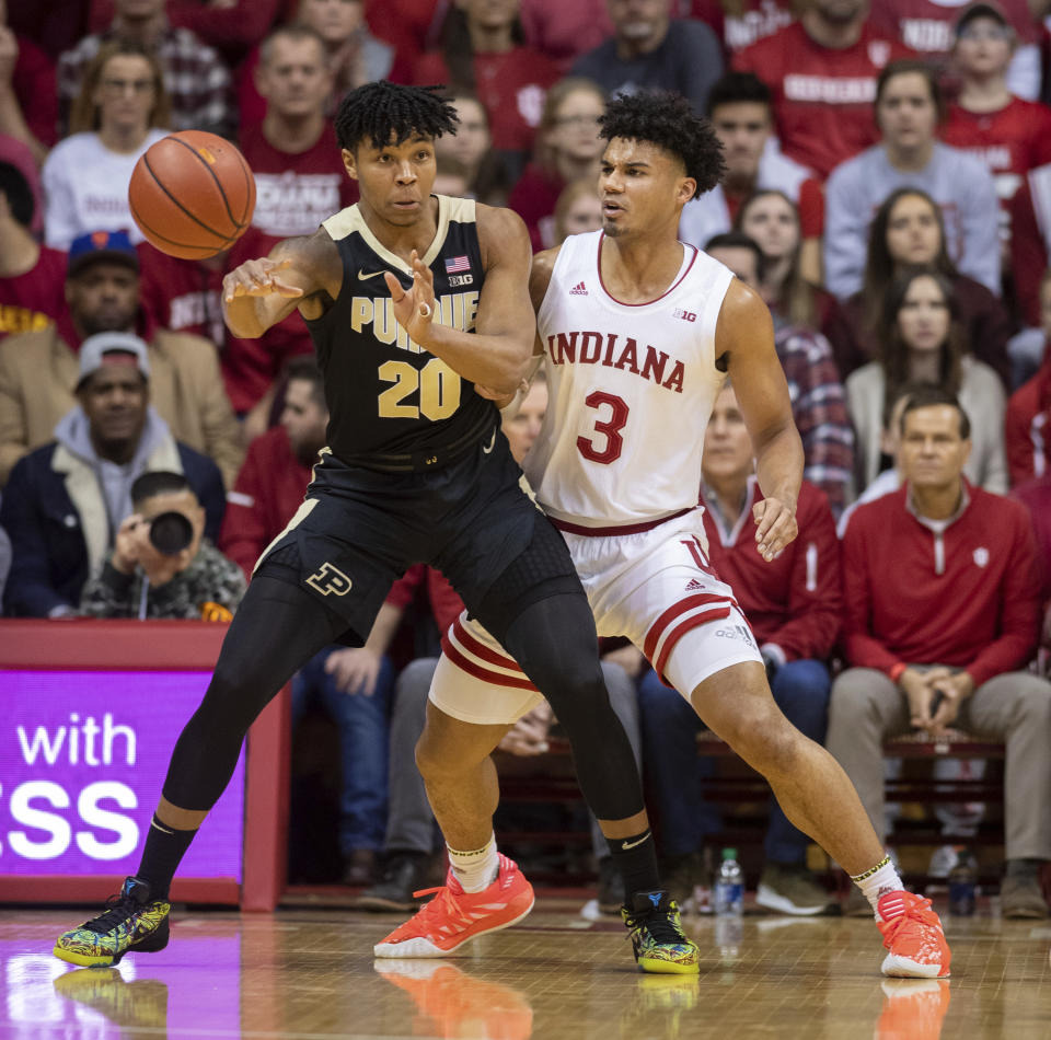 Purdue guard Nojel Eastern (20) makes a pass as Indiana forward Justin Smith (3) defends him during the first half of an NCAA college basketball game, Saturday, Feb. 8, 2020, in Bloomington, Ind. (AP Photo/Doug McSchooler)