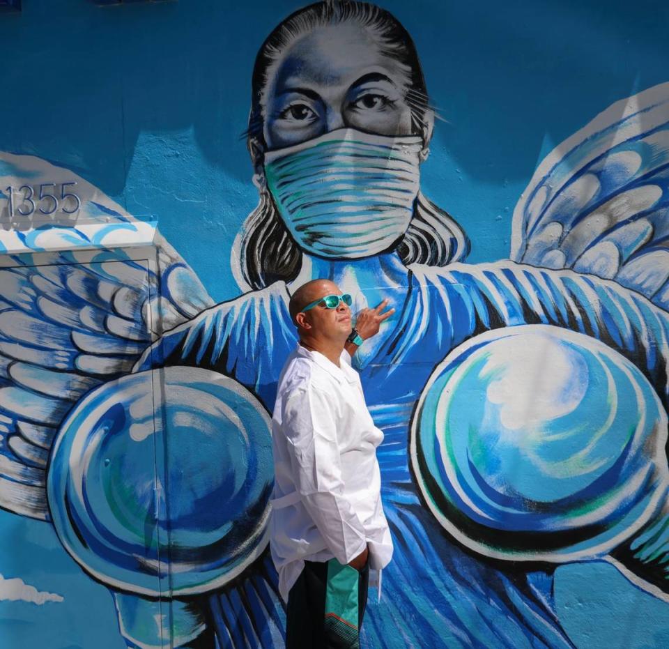 In honor of all nurses of different races, ages, and genders, Miami artist Kyle Holbrook, 45, expresses his gratitude for their service through his art by painting murals with brushes and acrylic paint on the exterior walls of Blue Angel Nurses Uniforms and Banu Scrubs on Wednesday, May 2, 2023.