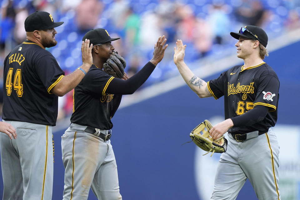 Pittsburgh Pirates' Jack Suwinski, right, Ke'Bryan Hayes, center, and Rowdy Tellez (44) congratulate each other after the Pirates beat the Miami Marlins 9-3, during a baseball game, Saturday, March 30, 2024, in Miami. (AP Photo/Wilfredo Lee)