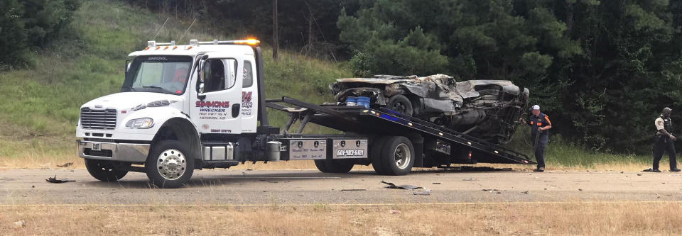 In this photo provided by The Macon Beacon, authorities remove one of several vehicles involved in a fatal crash Wednesday, June 5, 2019, near Scooba, Miss., in the same area where a crash took the lives of eight people two days earlier. Kemper County Sheriff James Moore told The Associated Press that "there will be fatalities" from the wreck on U.S. Highway 45 south of Scooba. (Jeanette Unruh/The Macon Beacon, via AP)